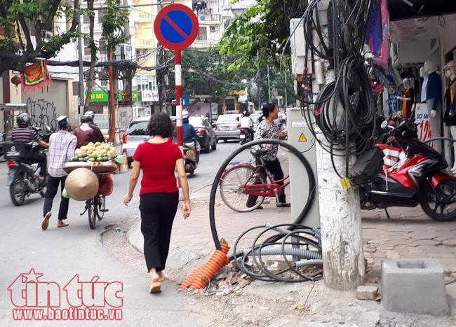 Dây điện, dây cáp viễn thông 'giăng bẫy' người dân trên phố ở Hà Nội ảnh 9
